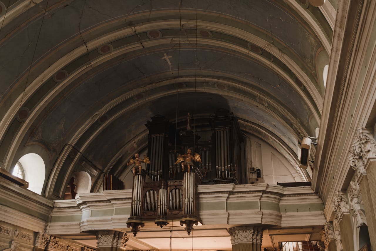 Intricate architectural details in a historic church, featuring ornate organ pipes.