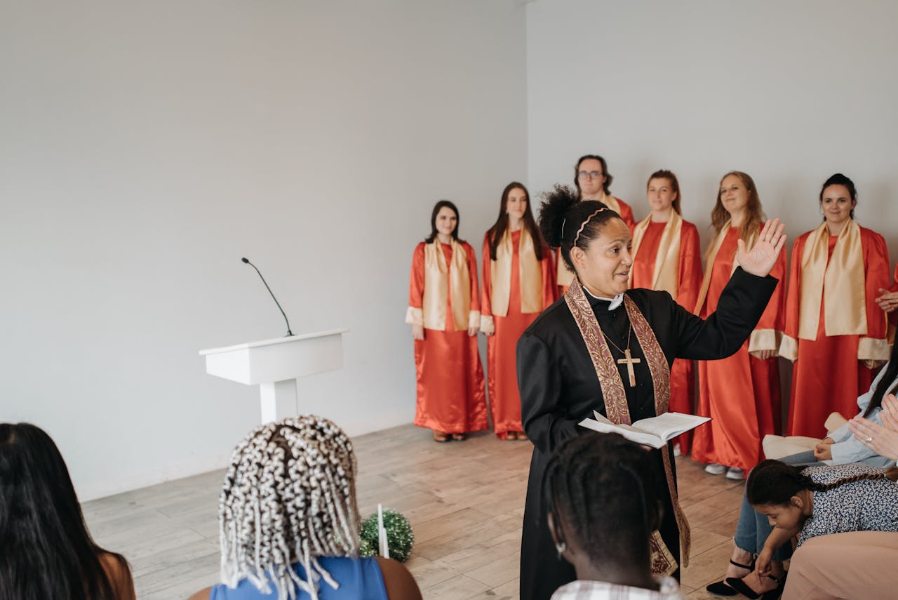 Mastering the First Impression: Your intriguing post title goes here A pastor leading a church ceremony with a choir in red robes in the background.